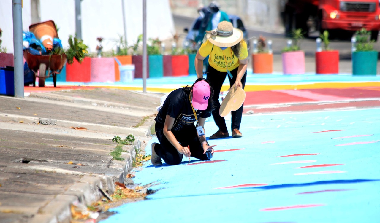 pessoas pintando as ruas com tintas coloridas
